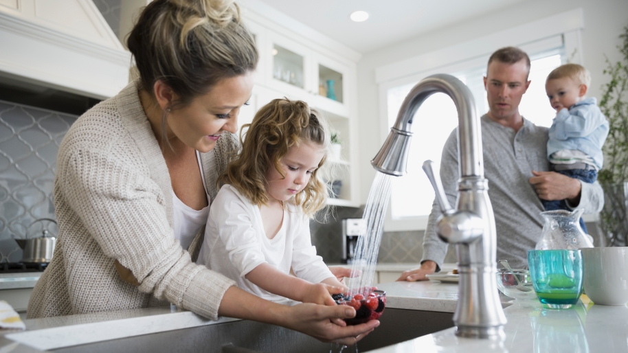 Woman and child washing a fruit
