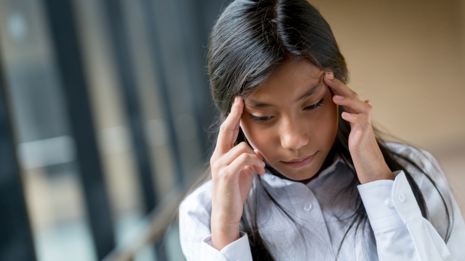 Girl with fingers on her temples