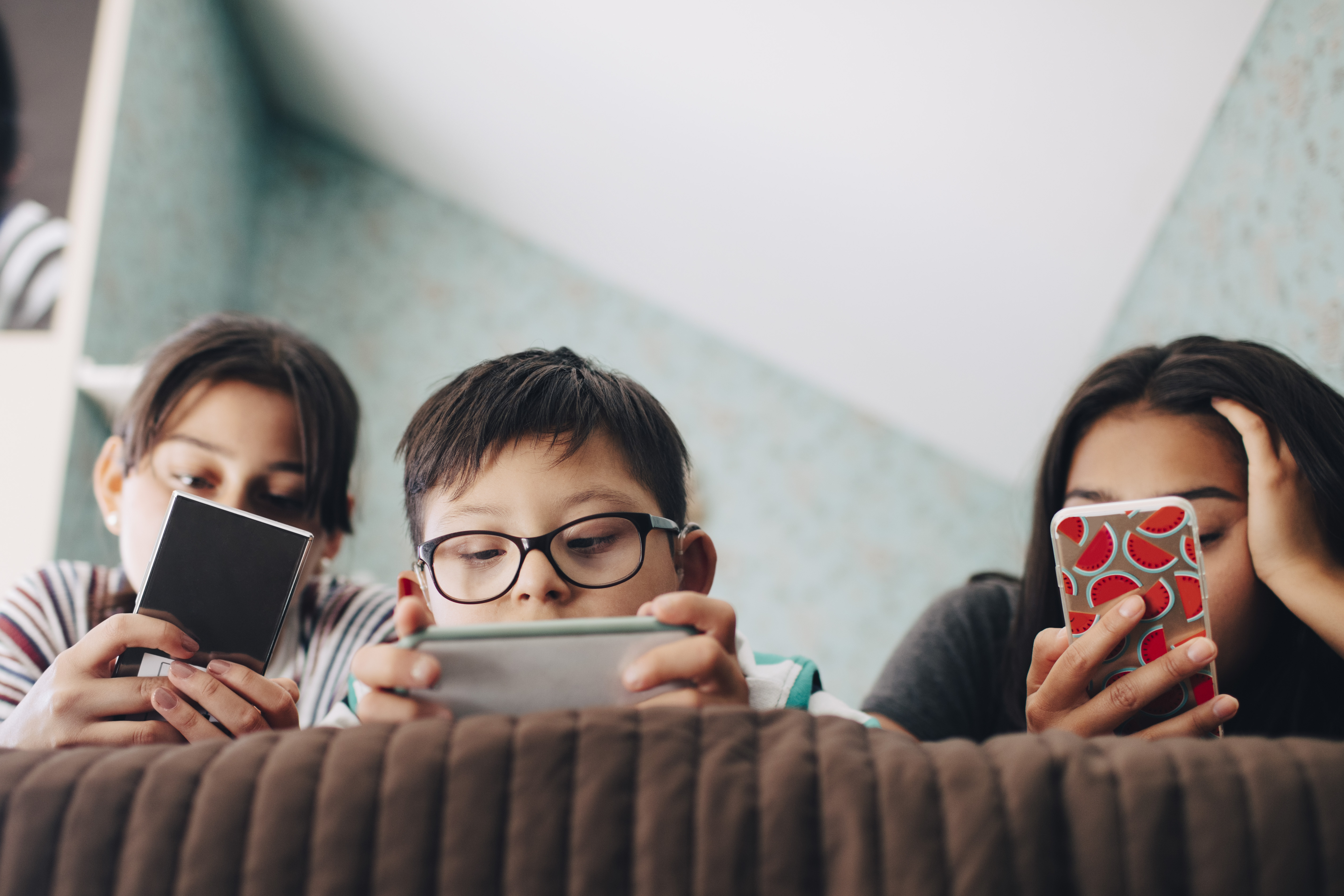 Children looking at cellphones
