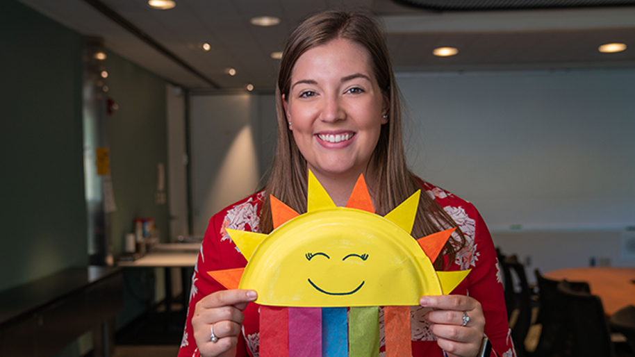 Woman holding a rainbow sun plate