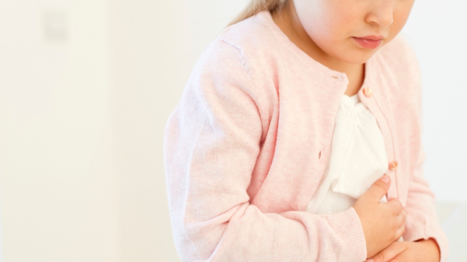 Little girl holding her tummy