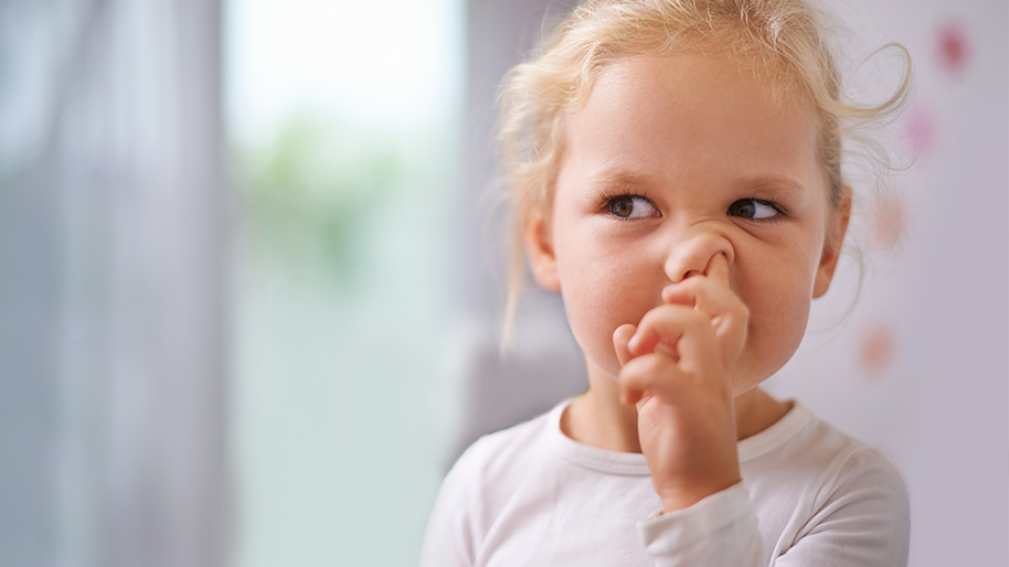 Little girl with finger in her nose