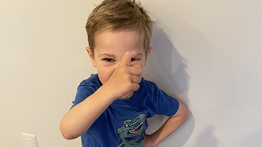 Child acting out to charades game for someone to guess