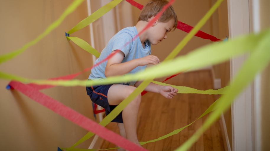Little boy playing in the hallway laser maze