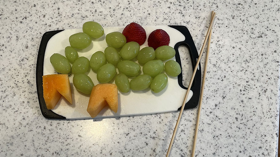 Grapes, melon and strawberries washed and on a plate to assemble.