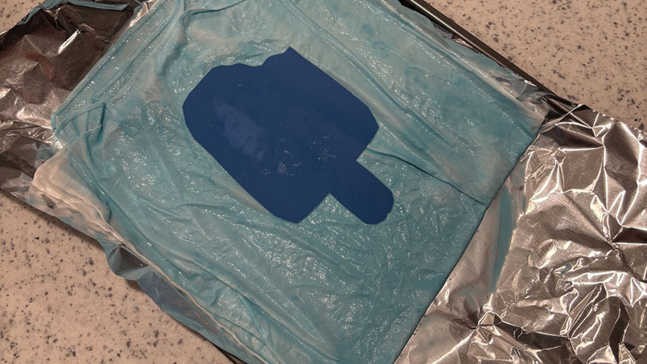 Wet blue bandana on foil in the sun.
