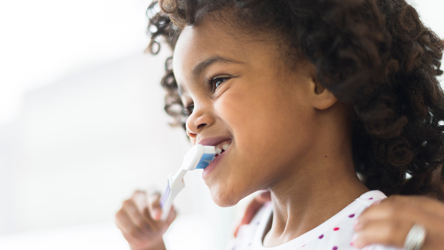 Little girl brushing her teeth