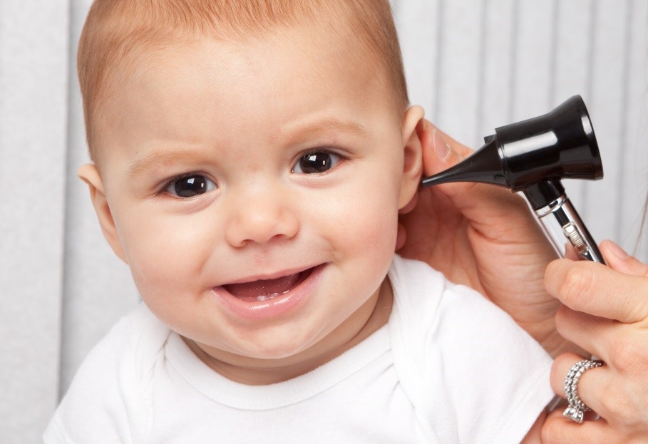 Child being examined for ear pain