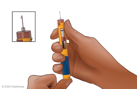 Priming the needle, with close-up of insulin coming out of the needle Priming the needle, with close-up of insulin coming out of the needle