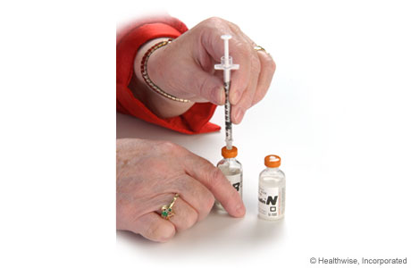Forcing air into the clear insulin bottle Forcing air into the clear insulin bottle