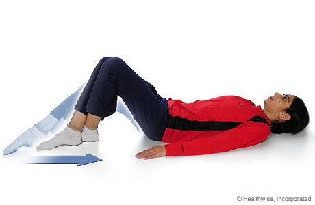 A woman doing the knee-flexion-with-heel-slide exercise A woman doing the knee-flexion-with-heel-slide exercise