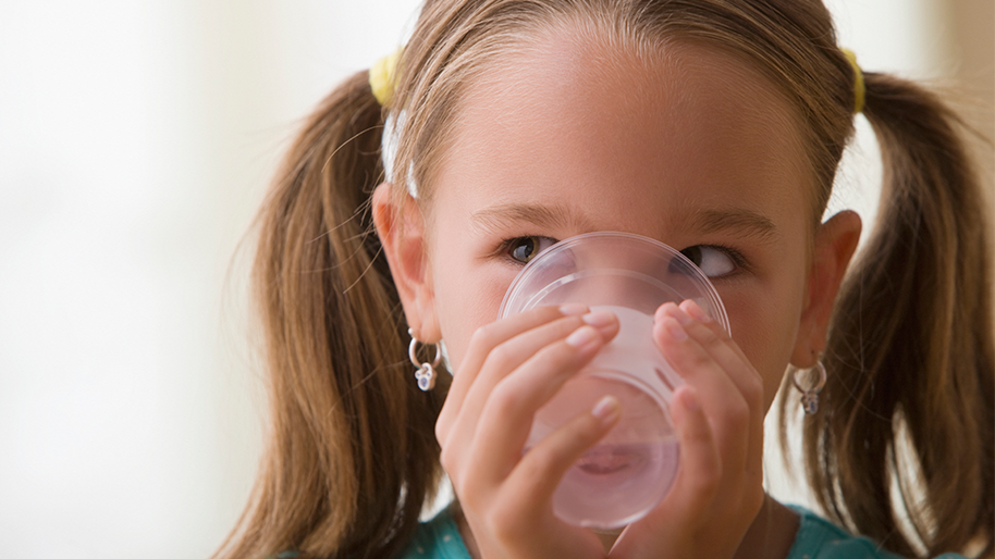 Girl drinking water from a glass