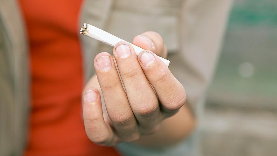 Hand holding a cigarette