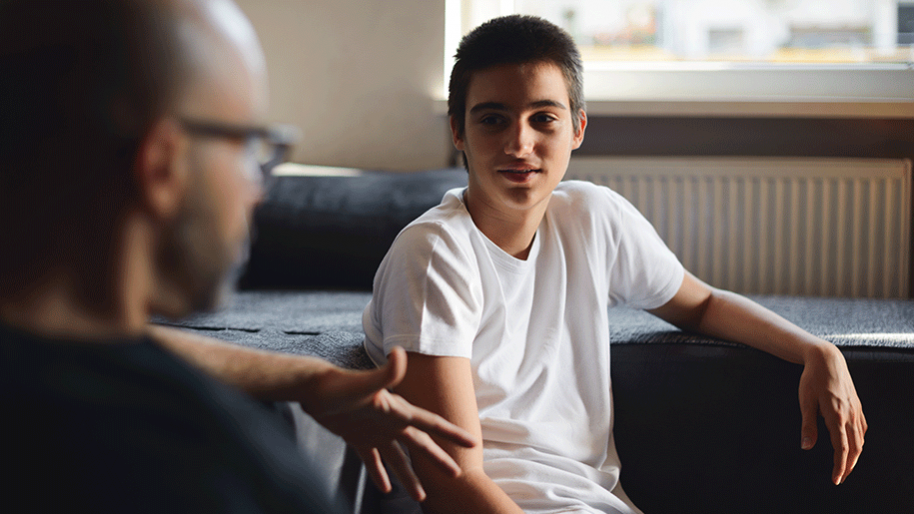 Boy talking to an older man