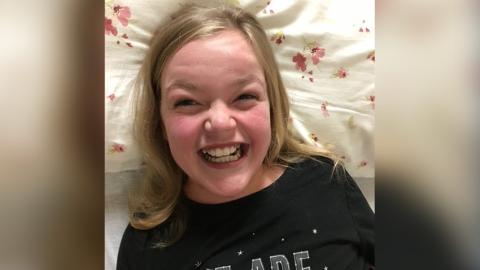 Maren Robinson smiling from her hospital room
