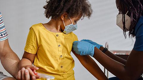 child receiving a vaccine