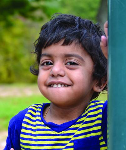 A young U-M patient smiling at the playground.