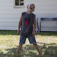 boy in yard smiling