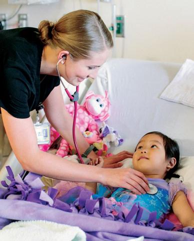 Nurse checking on a young patient