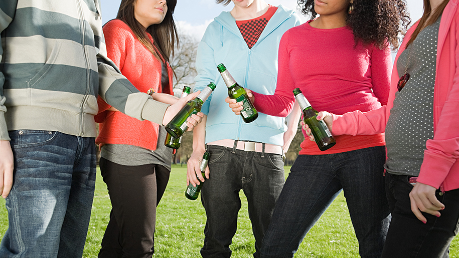 Five teens with beer bottles in their hands