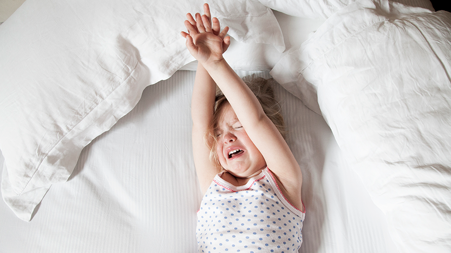 Young girl on her back having a tantrum